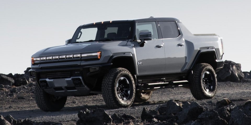 White 2024 Hummer EV on rocky terrain