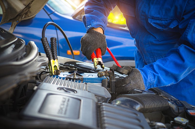 Man checking battery charger Of car